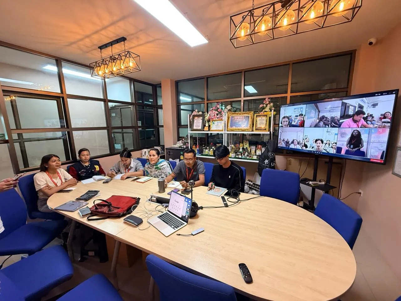 PAN staff in the Nong Chok meeting room on a video call with the branch teams
